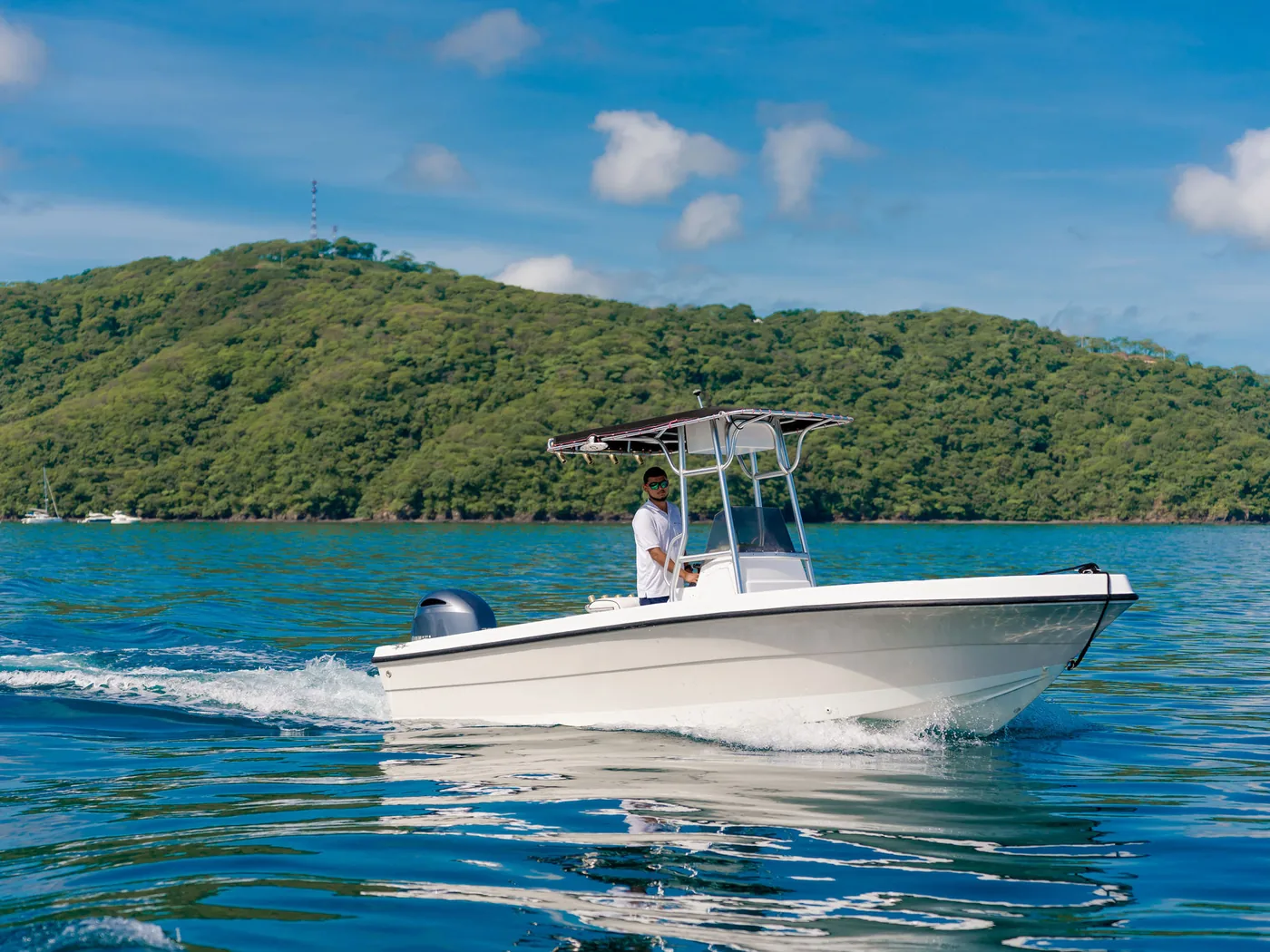An Ocean Club center console fishing boat running on blue Pacific water off Costa Rica