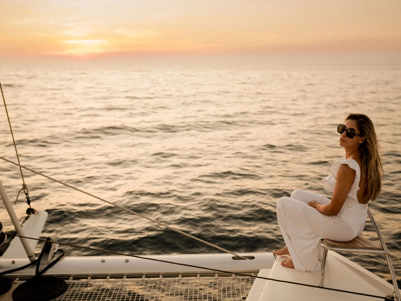 A couple watching the sunset from the deck of an Ocean Club catamaran on the Pacific coast of Costa Rica