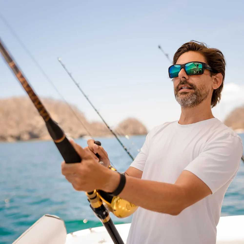 An angler fighting a fish from the stern of an Ocean Club charter boat, Costa Rica