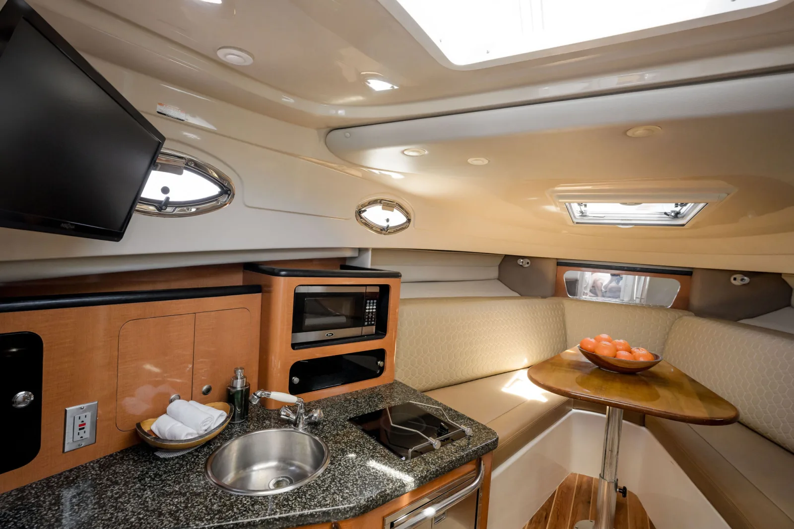Disparate's cabin and galley, finished in wood with a sink and worktop