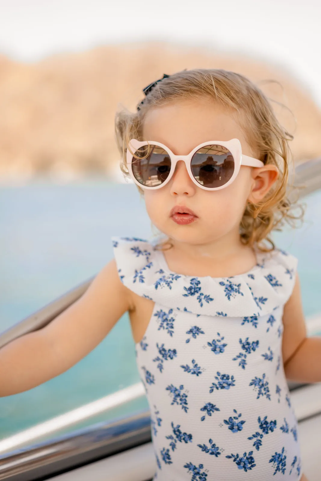 A young guest aboard Disparate, shaded under the hardtop