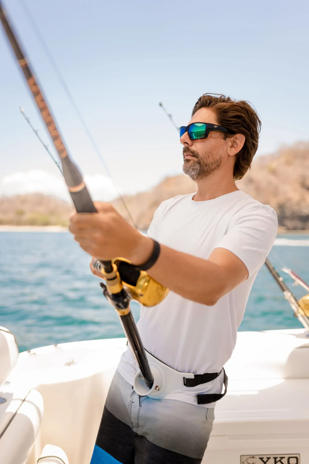 An angler working a fish from Disparate's cockpit