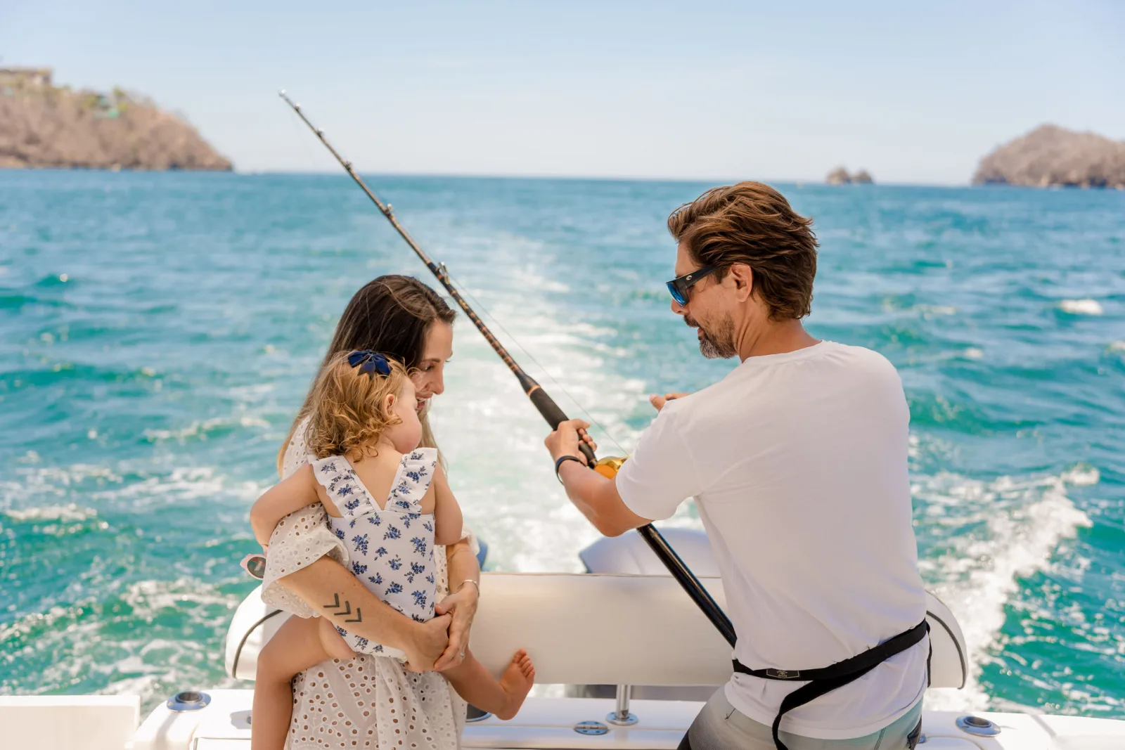 Two guests fishing together from the back of Disparate