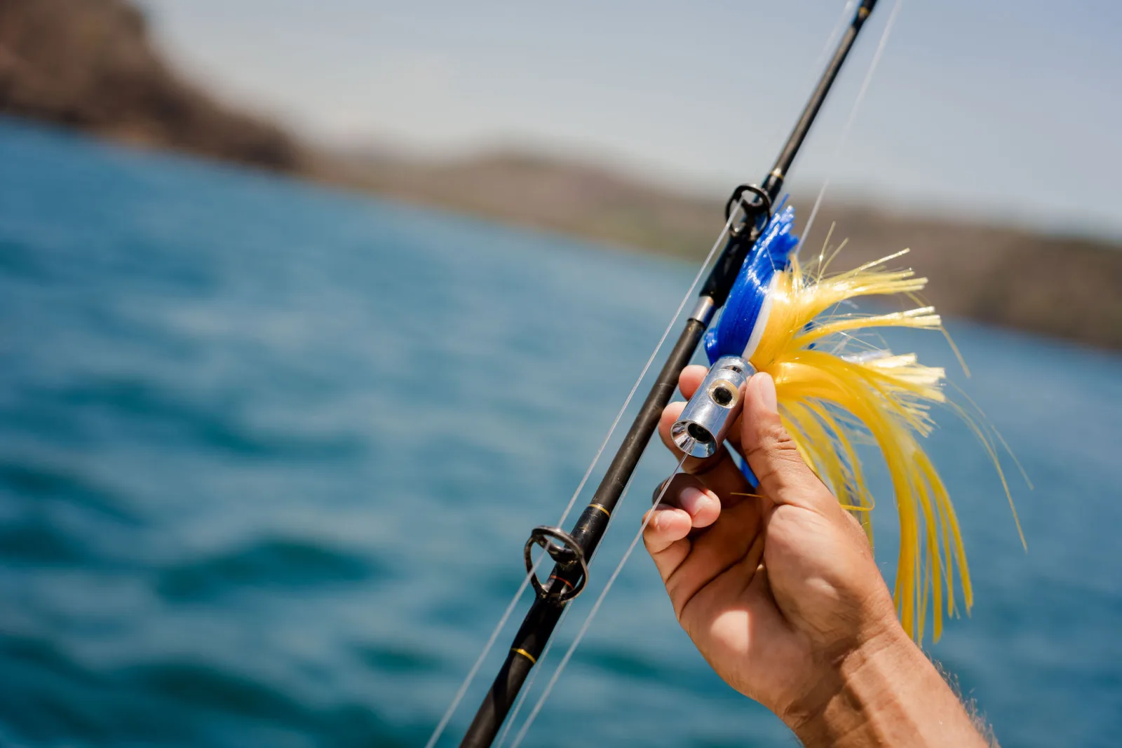 A reel and rod in the holder aboard Disparate