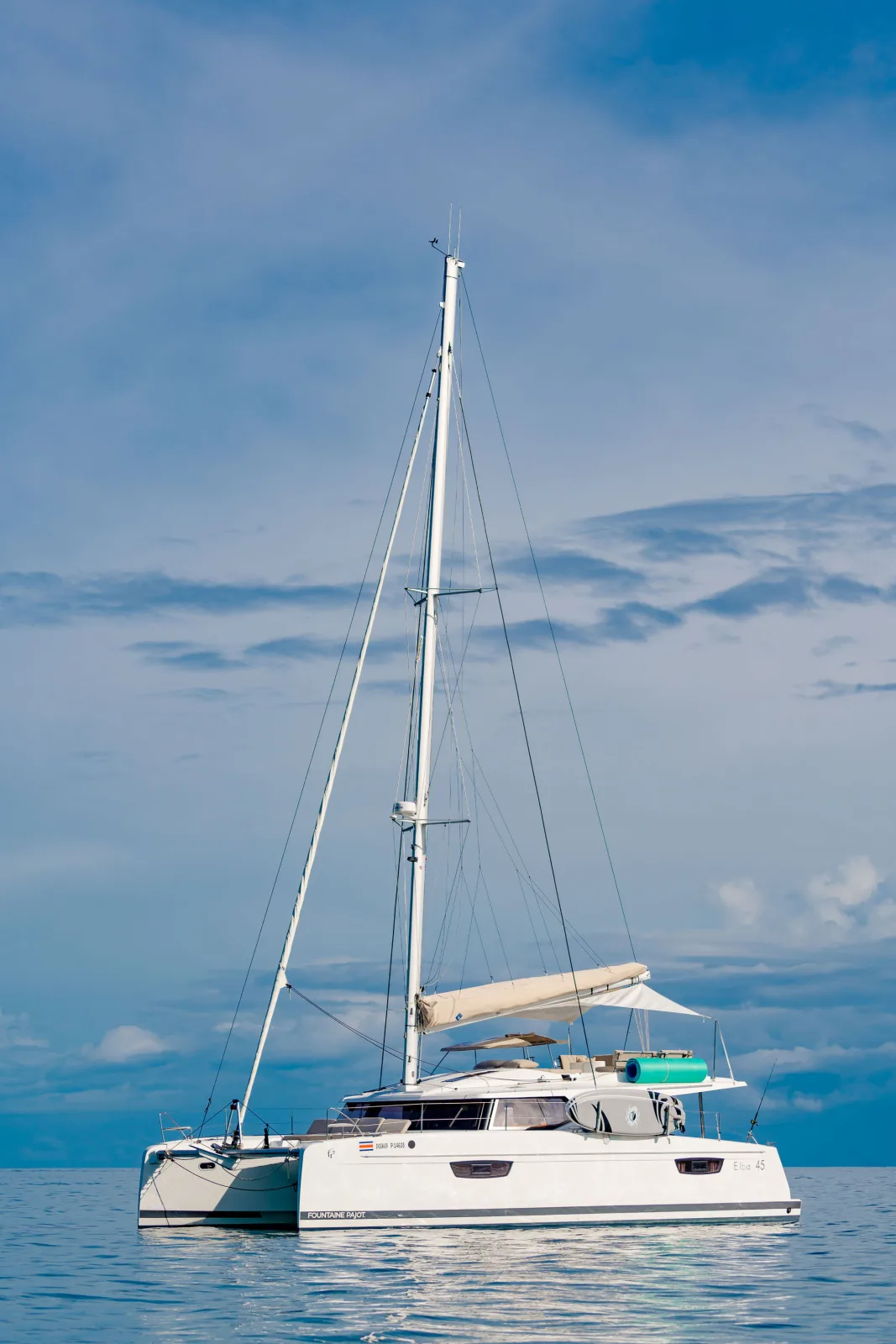 Endeavour lying at anchor on flat water off Guanacaste, mast and rigging against a clear sky