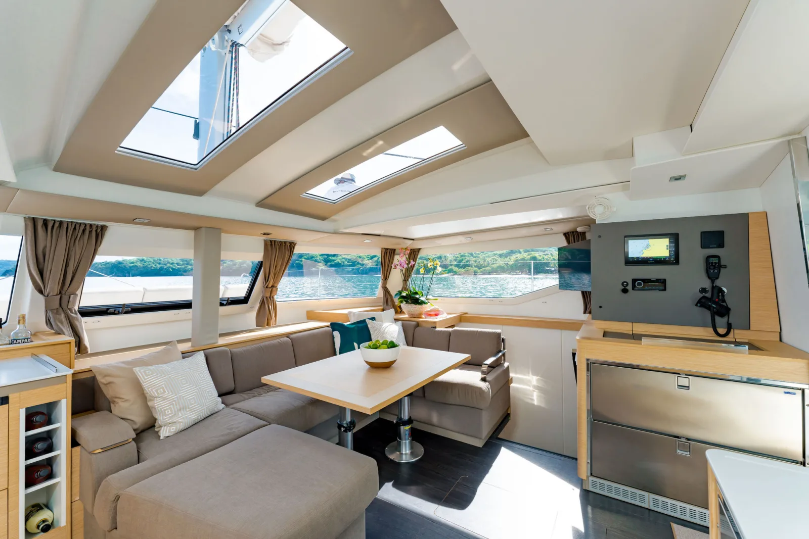 Endeavour's saloon, with the dining table and galley under panoramic windows