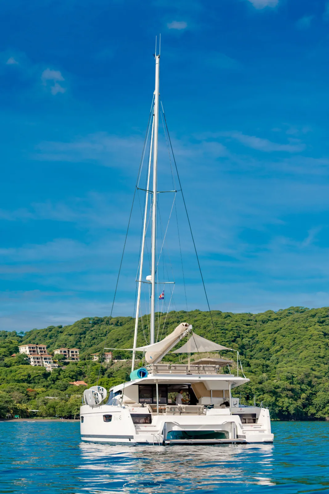 Endeavour at anchor close in to the wooded Guanacaste coastline