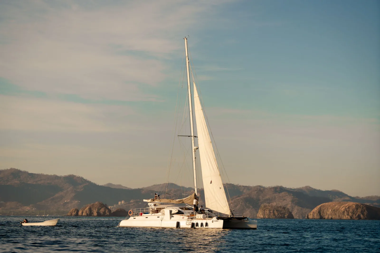 Lohe Lani under sail in golden light off the Guanacaste coast
