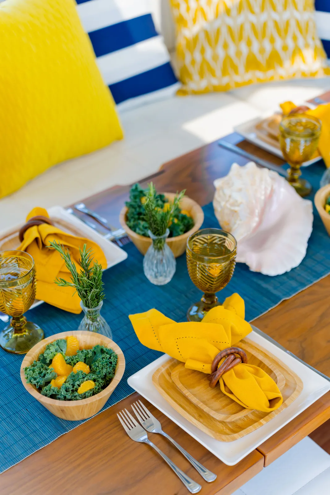 Lunch laid aboard Samia, yellow linen and fresh salad on the table