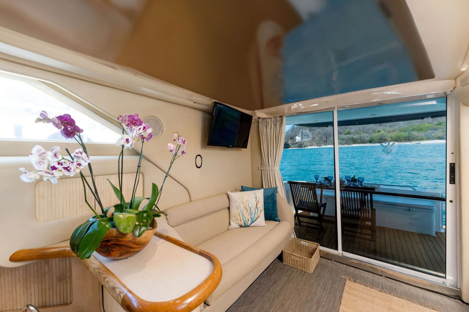 Sea Ya's interior, an orchid on the table and windows open to the water