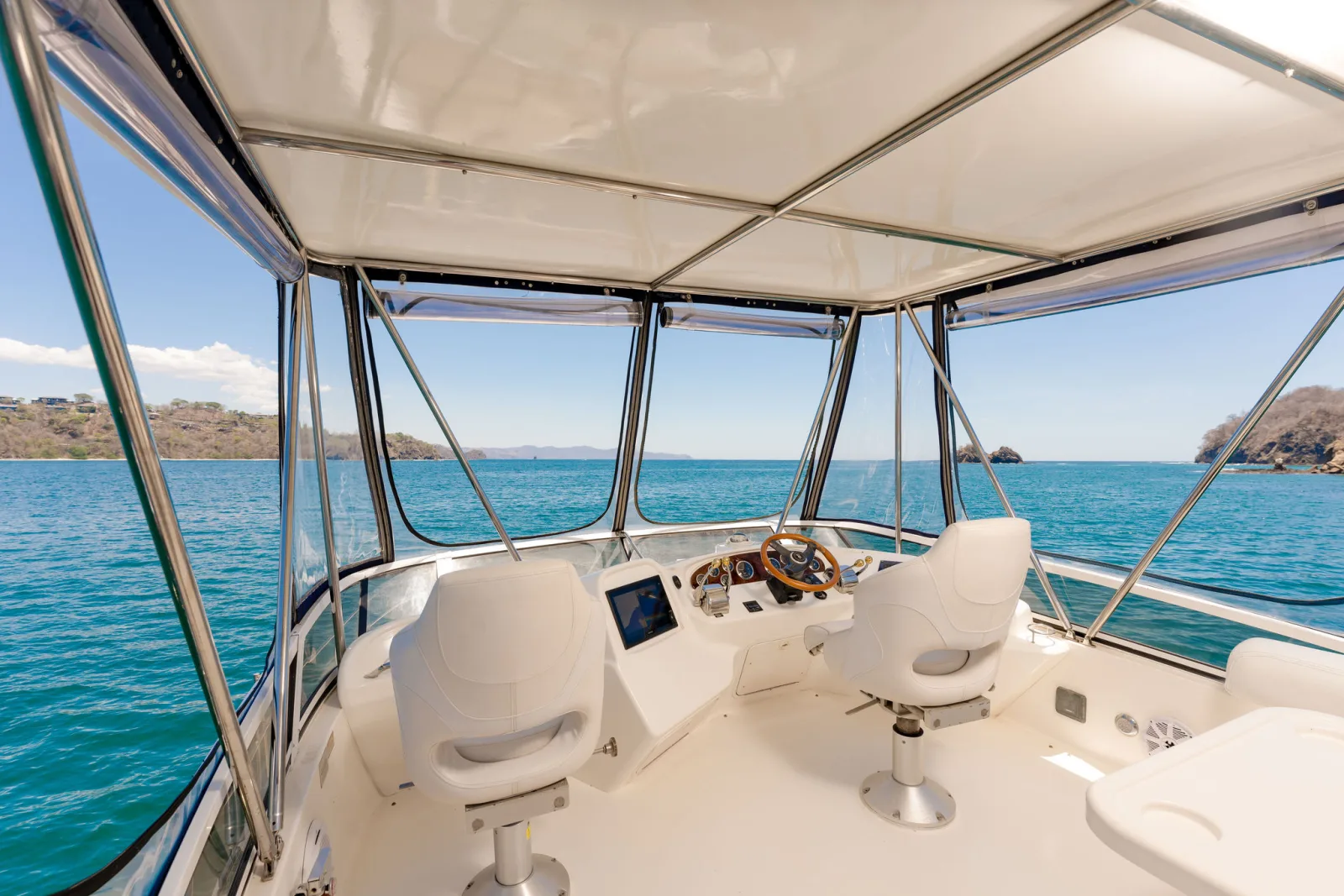 Sea Ya's flybridge, with shaded seating and the upper helm