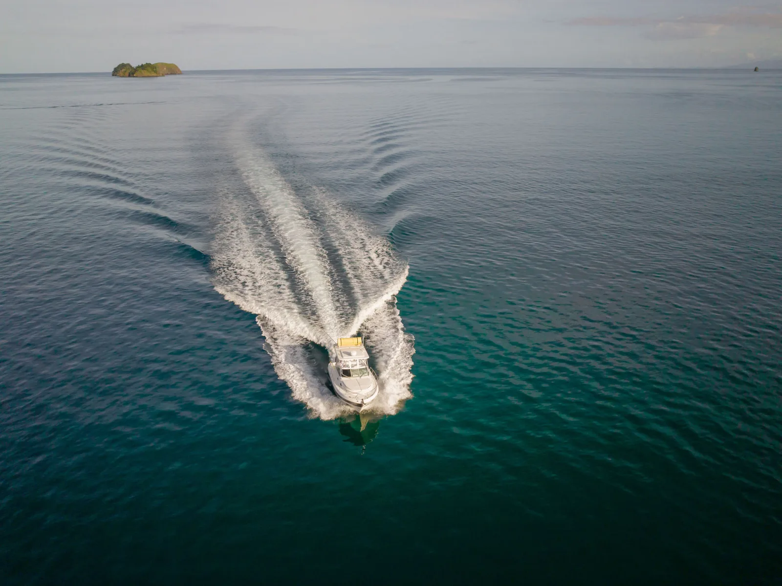 XQ running across open water, seen from above