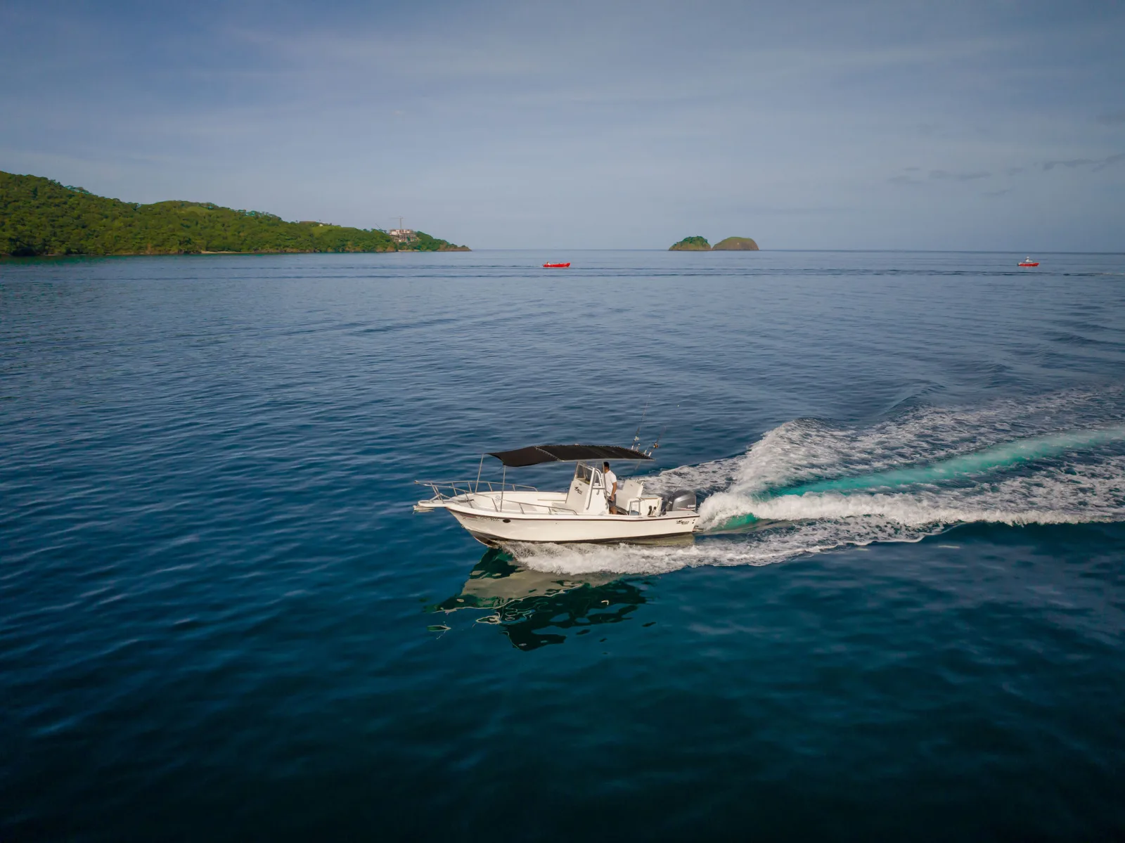 XQ lying off a small island in calm water